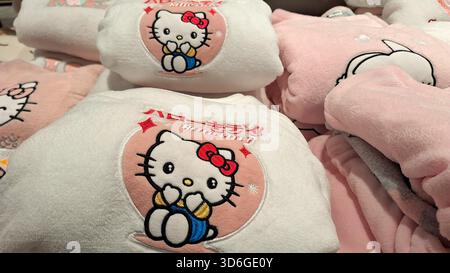 Russia, Moscow- 27 October 2025.Stack of plush Hello Kitty-themed blankets featuring colorful embroidered character designs Stock Photo