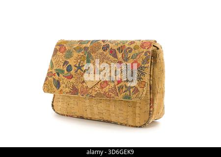 Cork handbag with vivid printed flap, photographed against a crisp white backdrop that enhances the color depth and natural texture. Stock Photo