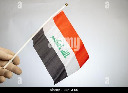 Tricolor design of the Iraqi flag featuring the green Arabic phrase, 'Allahu Akbar.' Stock Photo