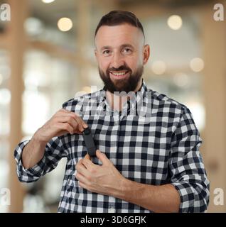 Man with hidden spy camera in office Stock Photo