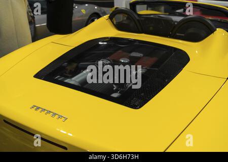 Milan, Italy - 12.11.2022: Luxurious yellow sports Ferrari car with powerful engine display at automotive show. Milano Autoclassica exhibition Stock Photo