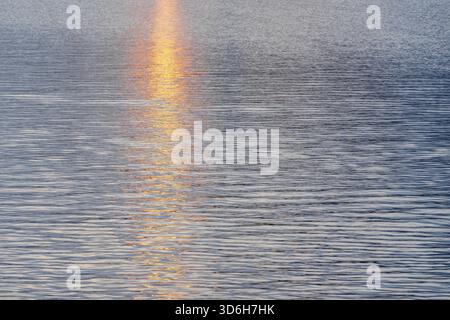 Abstract bokeh background from summer blue sea water at the beach - panoramic banner. Water bokeh backdrop Stock Photo