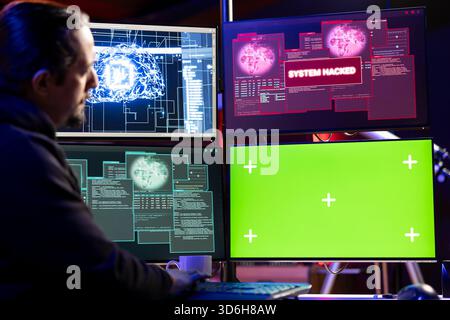 Hacker getting system hacked popup alert on green screen mockup computer after using malware software. Rogue engineer at home using chroma key PC to hide online activity after stealing data Stock Photo