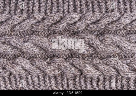 Wool grey knitted texture. Woolen gray cloth, handmade. Textile ornament. Fashion knitwear. Light wool yarn. Fabric texture. Winter scarf. Seamless pa Stock Photo