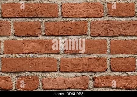 Seamless dark red brick wall texture background for design. Pattern of weathered old cracked brickwall. Stacked stones wall. Brick work wall from old Stock Photo