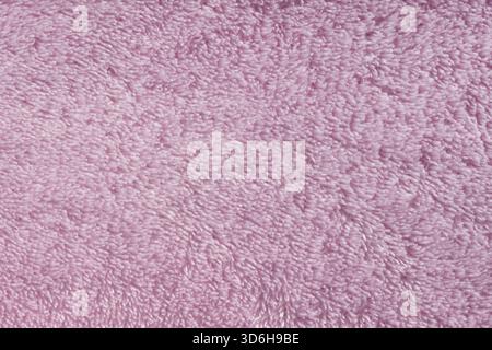 Pink fleecy synthetic fabric textile background. Soft plush fluffy cloth texture. Fuzzy pastel material for winter clothing, baby toys, and home texti Stock Photo