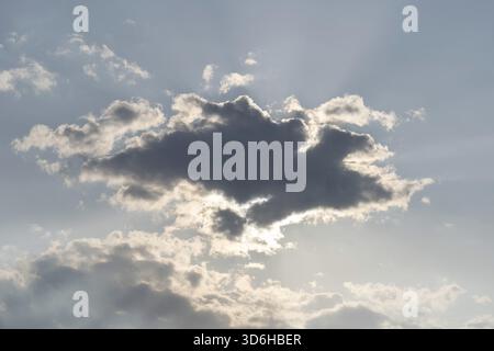 Big grey cloud hiding the sun. Magnificent panoramic cloudscape. Fluffy cumulonimbus cloud on blue sky. Cloudy sky at daytime Stock Photo