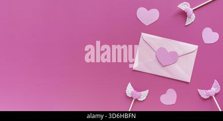 Valentine's day banner. Pink hearts, toppers, envelope with letter on pink background. Romantic, Valentines concept Flat lay, top view, copy space Stock Photo