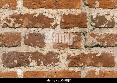 Orange brick wall texture background. Pattern of weathered old cracked brickwall. Stacked stones wall rough surface. Obsolete grunge surface. Vintage Stock Photo
