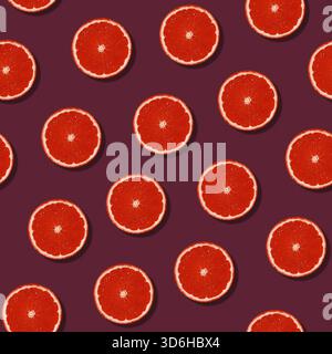 Colorful fresh grapefruit citrus slice seamless pattern. Fruits on bordo background. Creative color, summer friuts concept. Minimal style Stock Photo