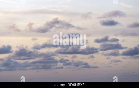 Cloudy sky at sunset or sunrise. Sky in the lilac and blue colors. Light pastel colored sunset clouds Stock Photo