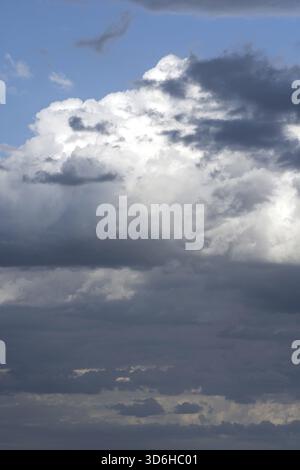 Sky with white and dark blue clouds. Dramatic cloudy sky background. Moody Cloudscape Stock Photo