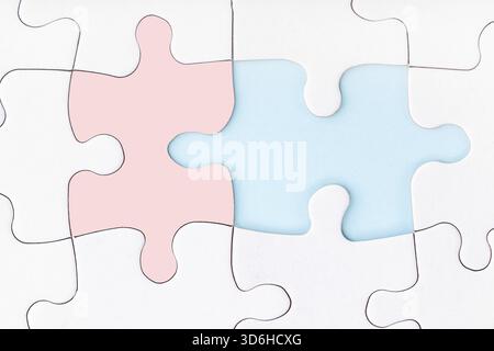 Male and female pieces of puzzle matching each other. Missing piece of jigsaw puzzle on blue background. Looking for love partner. Uncompleted puzzle. Stock Photo