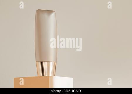 Liquid concealer packaging template mock up. Foundation bottle mockup on podium pedestal, beige natural background. Beauty cream cosmetics makeup prod Stock Photo