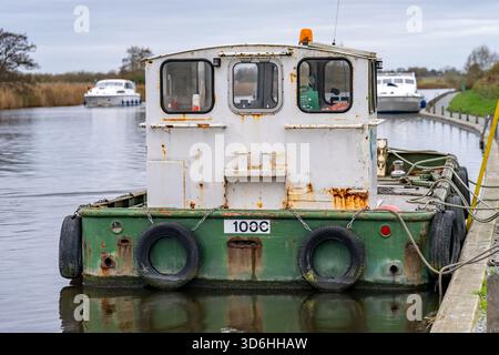 Rusty Broads Ranger boat tied up and moored to the jetty on the River ...