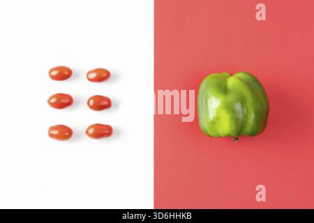 Creative layout made of pepper and cherry tomato on colorful red background. Pop art design, summer food concept. Healthy food minimal flat lay. Banne Stock Photo