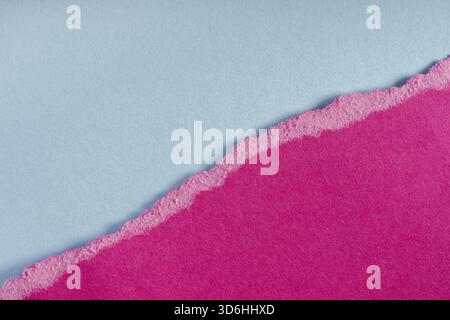 Pieces of torn ragged purple paper edges on blue background. Ripped cracked paper edge isolated with soft shadow. Paper piece torn edge. Copy space, f Stock Photo