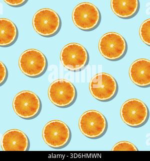Seamless orange fruit pattern on blue background. Colorful fresh citrus slice wallpaper. Creative color, summer friuts concept. Minimal style Stock Photo