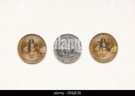 Different bitcoins on white grunge background Stock Photo