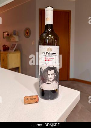19 Crimes wine bottle sitting on the edge of a kitchen counter with the label displaying a picture of a man. USA. Stock Photo