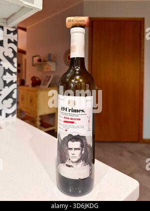 19 Crimes wine bottle sitting on the edge of a kitchen counter with the label displaying a picture of a man. USA. Stock Photo