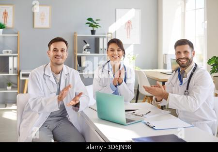 Portrait Of Doctors And Nurses Applauding And Celebrating Success Stock Photo