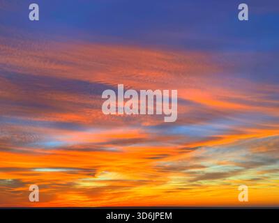 Fiery orange sunset sky clouds background Stock Photo