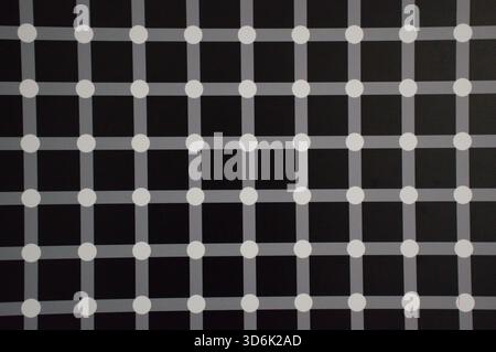 Abstract geometric pattern featuring a black background with intersecting gray lines and white dots, creating an optical illusion effect. Stock Photo
