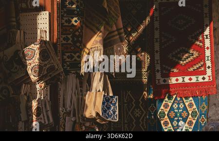 Traditional rugs hanging outside a shop in the old bazaar area of Mostar in Bosnia and Herzegovina on a sunny day, with different patterns. Stock Photo