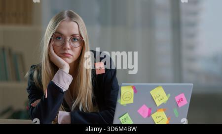 Tired burnout Caucasian business woman in office with stickers many tasks sticky notes with job work reminder feeling stressed businesswoman Stock Photo
