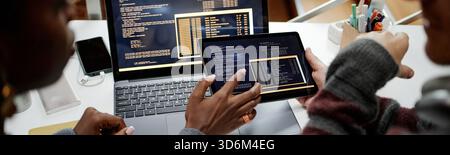 Header of Multiethnic Colleagues Reviewing Software Code on Tablet in Office Stock Photo