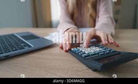 Close-up unrecognizable business woman in office with papers calculating finance company budget unknown female girl businesswoman working with laptop Stock Photo
