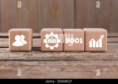 ISO 9001 Quality management systems. Cubes with different icons on wooden table Stock Photo