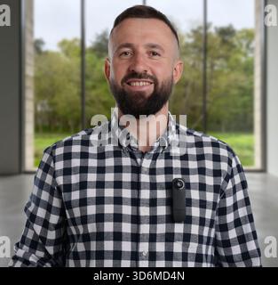 Man with hidden spy camera in room Stock Photo