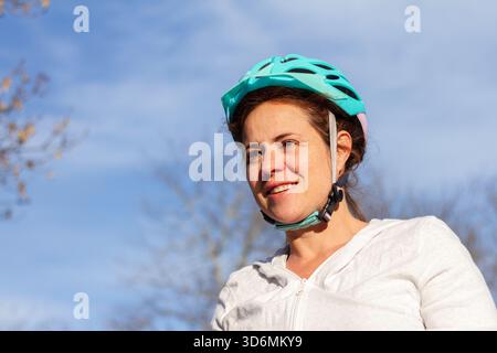 Portrait of an Active Woman with Cycling Helmet in Natural Light Stock Photo