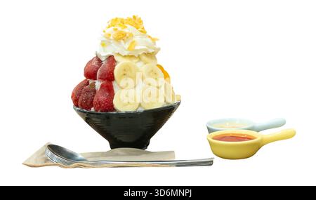 A set of Korean Bingsu in small black bowl with several fruits topping and red sauce with sweeten condensed milk in mini plastic bowls are isolated on Stock Photo