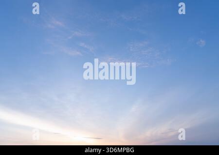 Beautiful morning or evening blue and orange sky with cloudy while sunsets or sunrises was taken at the sea used as natural background texture Stock Photo