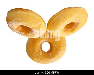 Side view of three brown sugar glazed cinnamon donuts in stack is isolated on white background with clipping path. Stock Photo