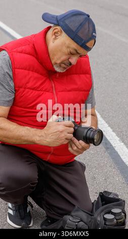 Senior man working as a photographer in a sports event Stock Photo