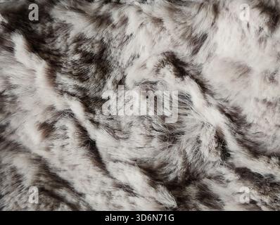 close up of luxurious faux fur texture in shades of gray and white for warm cozy background Stock Photo