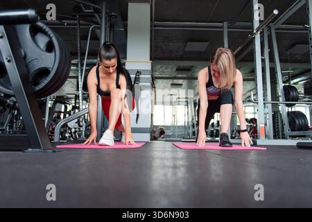 Front view of active women in sport outfit stretching body Stock Photo