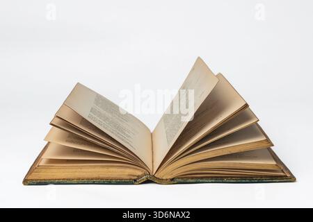 Antiquarian book open on a white surface Stock Photo