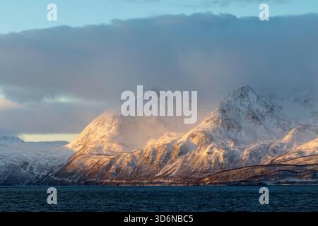 Golden Sunlight Breaking Through Arctic Clouds Stock Photo