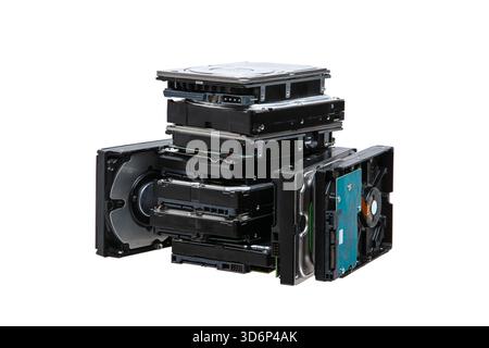 A large stack, pile  of internal computer hard disk drives, HDDs, isolated on a white background. Stock Photo
