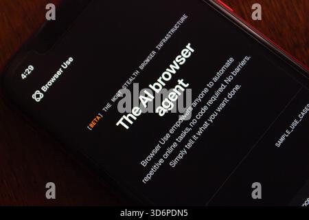 Quito, ECUADOR - Oct 6 2025 : Close-up of a smartphone showing a Browser Use website in dark mode, highlighting interactive AI-agent features. Stock Photo