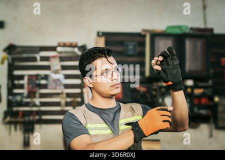 Carpenter carefully inspecting a piece in the carpentry workshop. Male carpenter checking a piece in the carpentry workshop Stock Photo