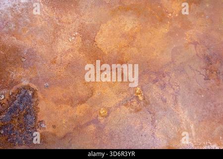 Rusty steel plate grunge texture varying hues of reddish-brown, orange, and dark brown. Rough uneven surface weathered. Stock Photo