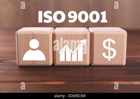 ISO 9001 Quality management systems. Cubes with different icons on wooden table Stock Photo