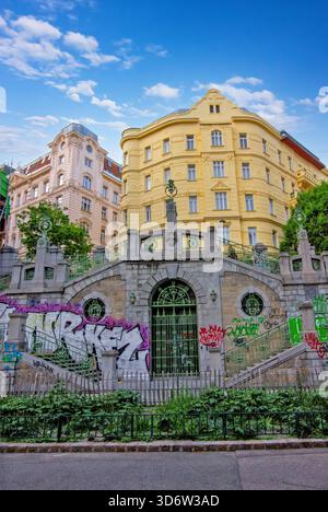 A historic stone staircase and archway covered in colorful graffiti in Vienna Stock Photo