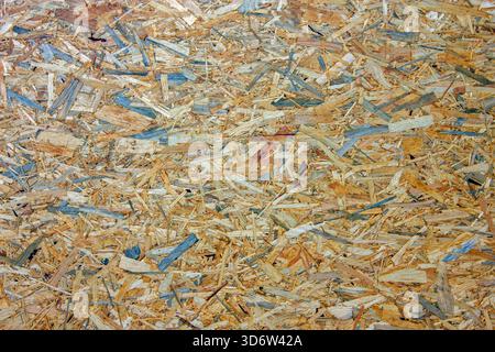 The image is a close-up of an Oriented Strand Board OSB or similar composite wood panel Stock Photo
